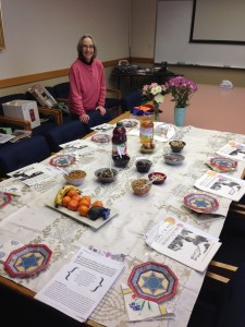 Janet Tatz, Jewish Educator, with the table set for a festive TuB'Shevat celebration on campus