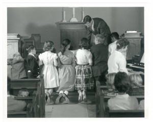 Intermountain children receive communion in Helen Piper Memorial chapel, Mills Hall (undated)