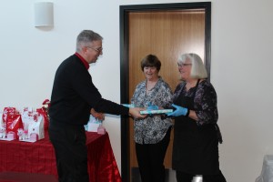 Chaplain Chris presents Janet and Jean, volunteers from St. Peter's Episcopal, with a gift to show our appreciation.